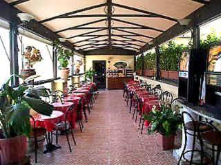 a dining room with red tables and chairs at Hotel Nardizzi Americana in Rome