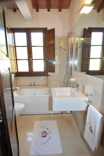 a bathroom with a tub and a sink and a toilet at Residence Prunali in Massarosa