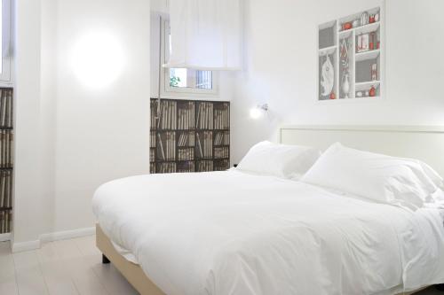 a white bedroom with a large white bed at Domus Municipio in Naples