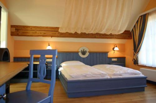 a bedroom with a bed with a blue ladder in it at Hotel Kirchbichl in Hallwang