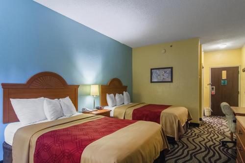 a hotel room with two beds in a room at Econo Lodge Darien in Darien