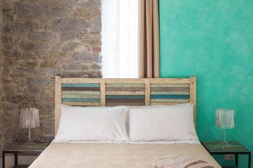 a bedroom with a bed with a brick wall at Agriturismo l'Adagio in Badalucco
