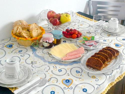 a table with a table cloth with food on it at Mocho GuestHouse in São Mamede