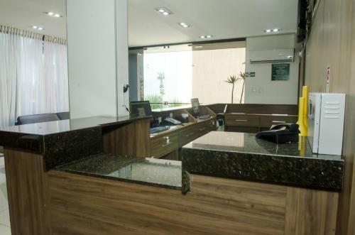 a kitchen with a sink and a counter top at Stop Inn Plus Pampulha in Belo Horizonte
