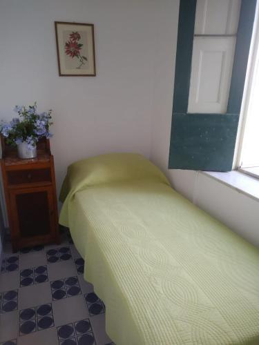 a small bedroom with a bed and a window at Nunziata in Mineo