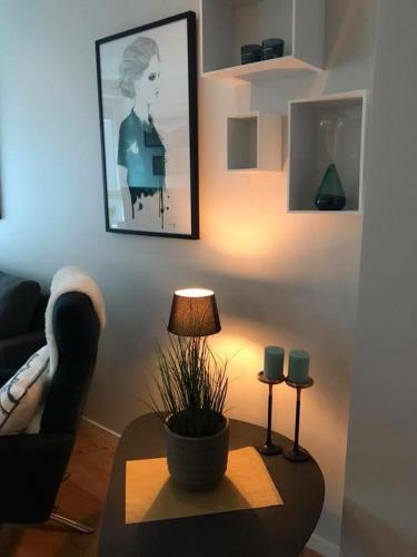a living room with a couch and a table with a lamp at Førde in Førde