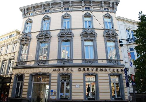 a white building with the words nedelevrevelt at Hotel Gravensteen in Ghent