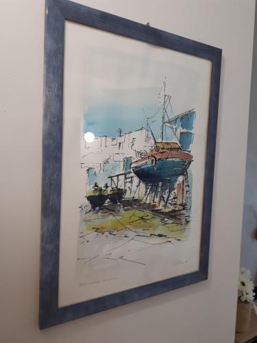 a painting of a boat on the water at Rainbow Sweet Rooms in Valmontone