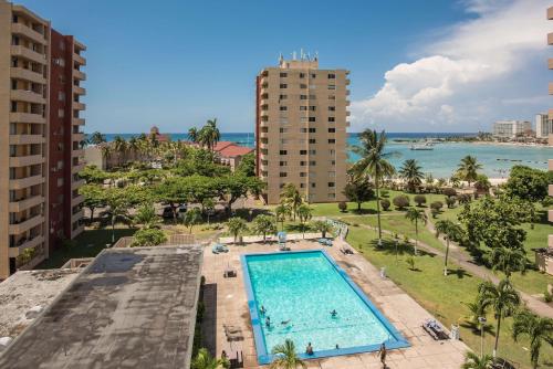 an aerial view of a swimming pool and the ocean at Turtle Beach Towers in Ocho Rios