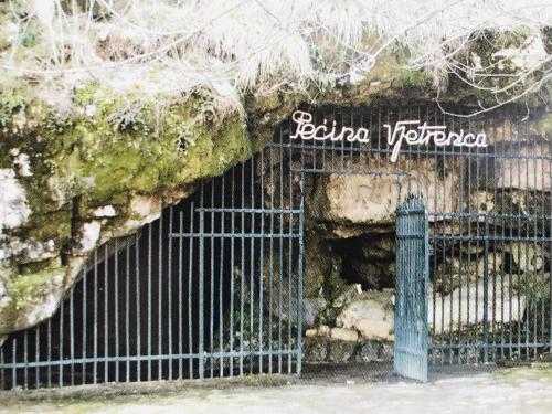 an entrance to a stone cave with a gate at Apartments Joja in Međugorje