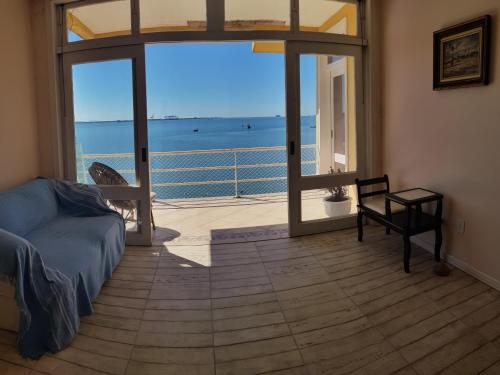 a living room with a view of the ocean at Pousada Pedra das Tartarugas in São Francisco do Sul
