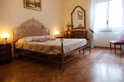 a bedroom with a large bed and a mirror at Maman Suite, city center near Molo Beverello in Naples