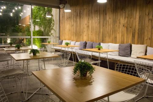 a row of tables with a couch in a restaurant at Lemon Suites in Buenos Aires