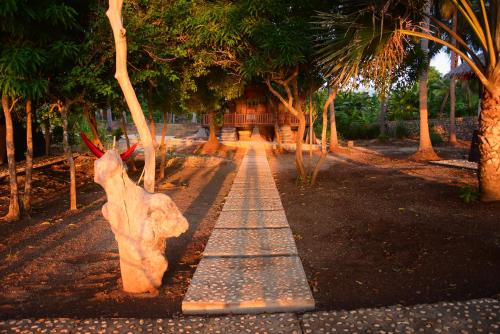 a statue of a rabbit on a walkway with trees at Sunari Beach Resort 2 in Selayar