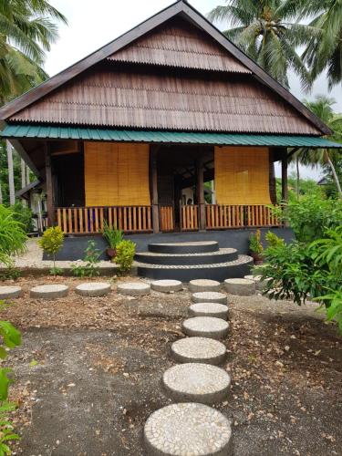 a building with stepping stones in front of it at Sunari Beach Resort 2 in Selayar