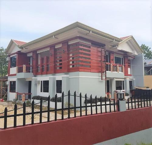 a house with a fence in front of it at Catalina`s Inn family room in Panglao