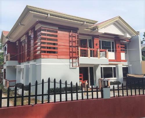 a house with a fence in front of it at Catalina`s Inn family room in Panglao
