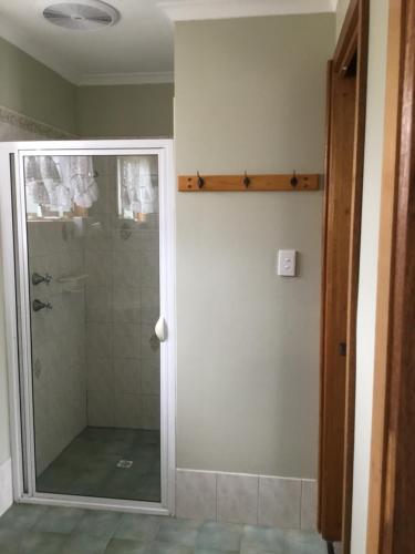 a shower with a glass door in a bathroom at Millicent Lakeside Caravan Park in Millicent