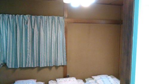 a bedroom with two beds and a window in it at "Cherry House" is Direct to Narita,Haneda AP, Disney, Asakusa, Skytree Tower, Tokyo in Matsudo