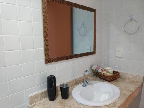 a bathroom with a sink and a mirror at Ap 2/4 na Reserva Imbassaí in Imbassai
