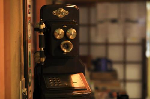 an old fashioned phone is attached to a door at Jinpuso in Miyazu