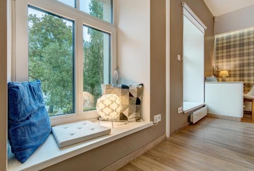 a room with a window with a vase on a window sill at HaPPy InnSide, Free Parking, Self check-in 7x24h, AC in Vilnius