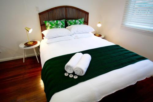 A bed or beds in a room at Tea Gardens Hotel