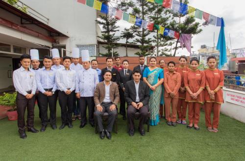 a group of people posing for a picture in front of a building at Avataar Kathmandu Hotel in Kathmandu