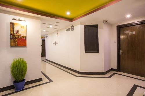 a hallway with a door and a potted plant at Avataar Kathmandu Hotel in Kathmandu