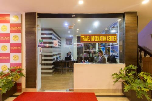 a restaurant with two people sitting at a counter at Avataar Kathmandu Hotel in Kathmandu