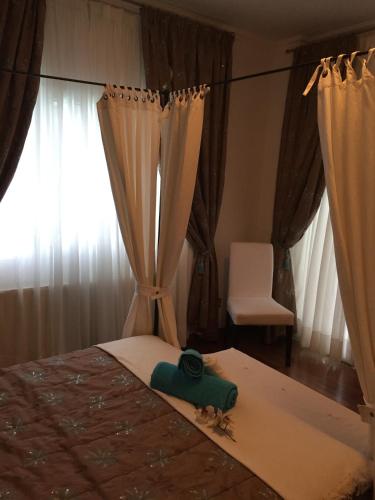 a bedroom with a bed and a chair and a window at Deluxe First Line Villa in Pervolia
