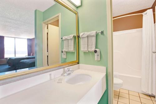 a bathroom with a sink and a mirror at Super 8 by Wyndham Gaffney in Gaffney