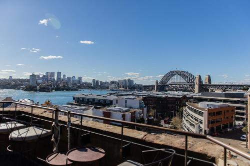 a view of a city with a bridge and a harbor at Hotel Palisade in Sydney