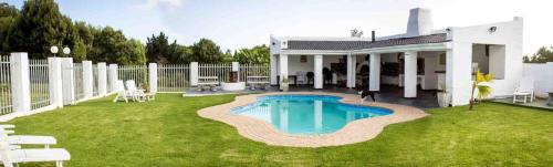 a house with a swimming pool in the yard at Victoria Heights B&B in George