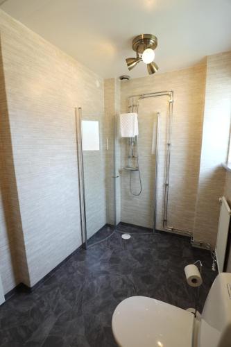 a bathroom with a shower and a sink at Kosta Lodge in Kosta