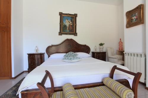 a bedroom with a large bed and a chair at B&B Villa Maiolica in San Leone