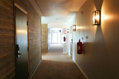 a hallway with a door and a hallway with a fire extinguisher at Kosta Lodge in Kosta
