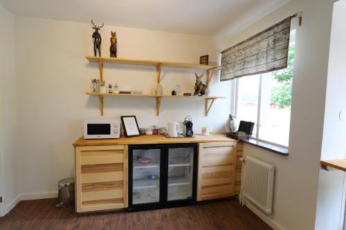 a kitchen with a counter and shelves and a window at Kosta Lodge in Kosta