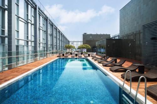 a swimming pool on the roof of a building at Novotel Ambassador Seoul Dongdaemun Hotels & Residences in Seoul