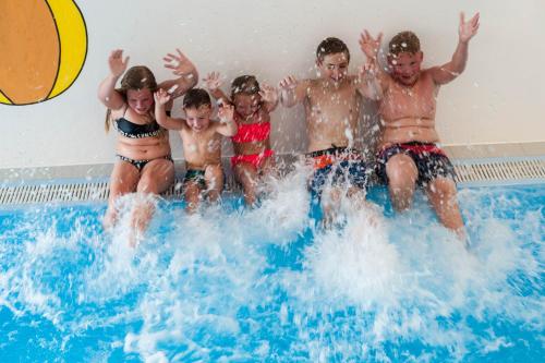 a group of people in a swimming pool at Pitzis Kinderhotel - Family Only in Arzl im Pitztal