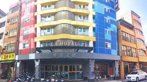 a building with a colorful facade on a city street at La Hotel-Baseball Theme Hall in Kaohsiung
