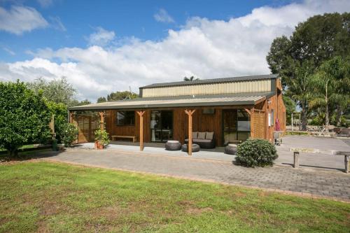 a house with a pavilion in a yard at Pickering Barn Stay in Tamahere