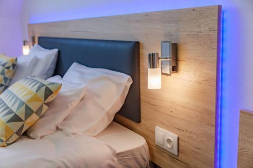 a bedroom with a bed with pillows on it at Christina Residence in Budapest