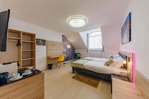a bedroom with a king sized bed and a tv at Christina Residence in Budapest