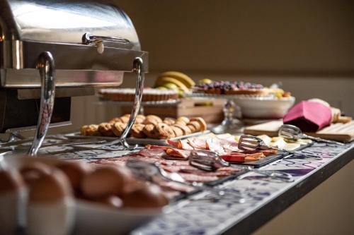 a buffet with different types of food on a table at Allegroitalia San Gallo Firenze in Florence