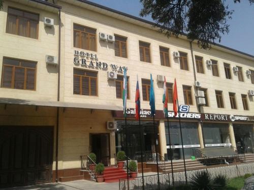 a large building with flags in front of it at Hotel "GRAND WAY" in Tashkent