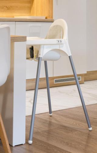 a white chair sitting next to a kitchen counter at HaPPy InnSide, Free Parking, Self check-in 7x24h, AC in Vilnius
