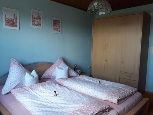 a bedroom with a bed with two pillows on it at Ferienhof Weydringer in Haundorf