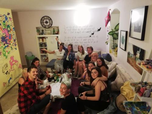a group of people sitting in a living room at Hostel Wonderful World in Split