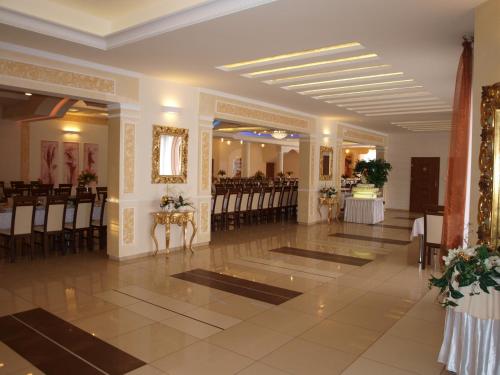 a banquet hall with chairs and tables in a building at Hotel Ostoja in Bobowa